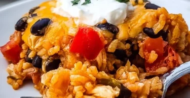 Cheesy chicken taco casserole with black beans in a baking dish
