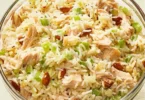 Delicious Chicken Rice Salad topped with fresh vegetables and dressing