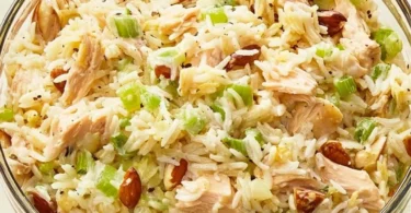 Delicious Chicken Rice Salad topped with fresh vegetables and dressing