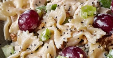 Chicken grape pasta salad with poppy seed dressing on a serving dish