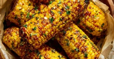 Delicious Cowboy Butter Roasted Corn served at a summer barbecue.