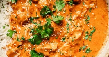 Delicious plate of Crockpot Butter Chicken garnished with fresh herbs