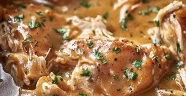 Crockpot chicken thighs in rich gravy served with vegetables
