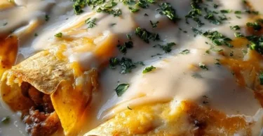 Delicious breakfast enchiladas topped with creamy sausage gravy ready to serve.