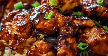 Honey BBQ Chicken Rice dish garnished with herbs and served on a plate.