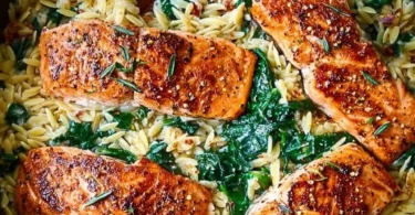 One Skillet Salmon served with lemon orzo on a plate