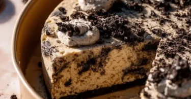 Delicious homemade Oreo Cookie Cake topped with crushed Oreos and frosting