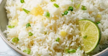 Delicious Pineapple Rice dish garnished with fresh herbs and colorful vegetables.